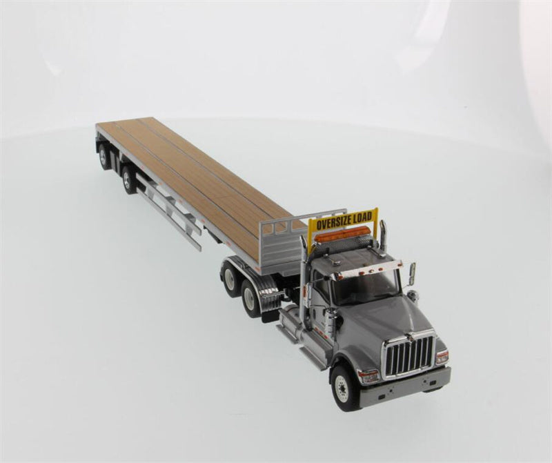 CATERPILLAR  International HX520 Tandem Tractor with 53′ Flat Bed Trailer – Light grey truck + Silver trailer 1:50 Truck Pre-built Model
