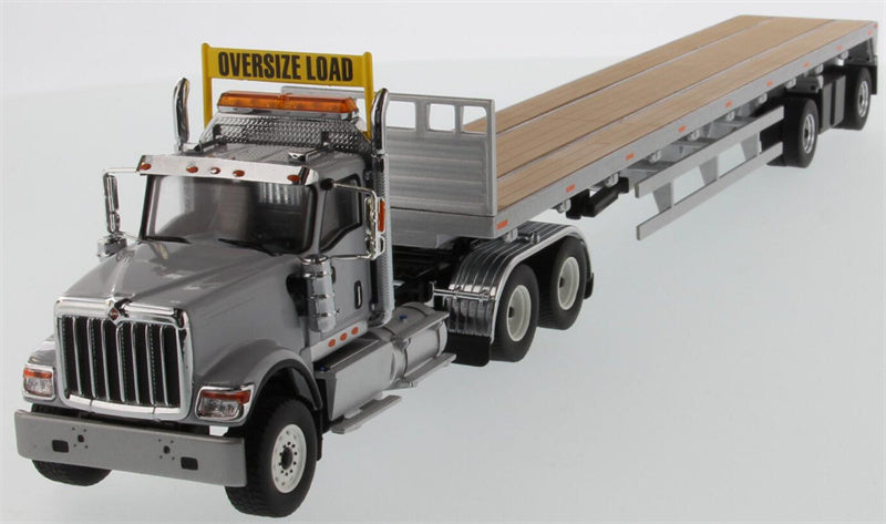 CATERPILLAR  International HX520 Tandem Tractor with 53′ Flat Bed Trailer – Light grey truck + Silver trailer 1:50 Truck Pre-built Model